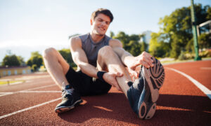 Tired athlete on the run course — illustrating bonking and cramping in endurance sport