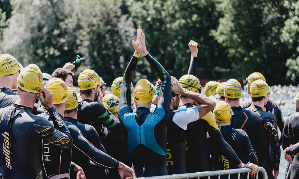 triathletes lining up for the swim portion of a triathlon