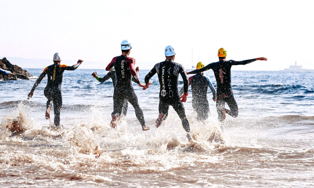 Swimmer entering the water at a triathlon race