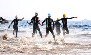 Swimmer entering the water at a triathlon race