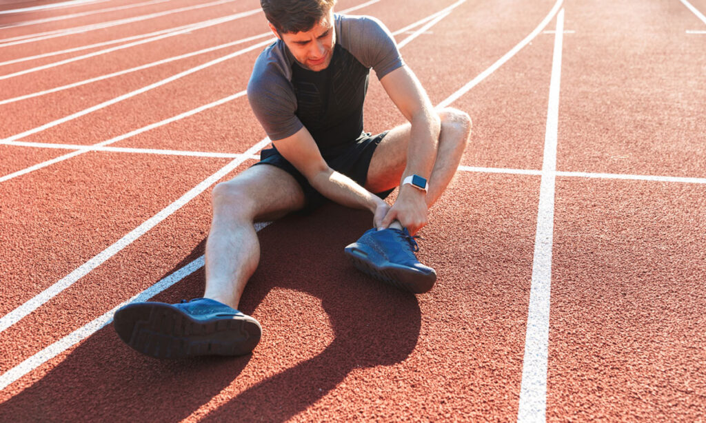 injured runner on a track