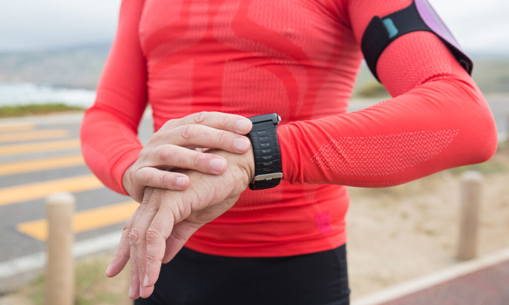 runner checking heart rate on a wrist gps watch