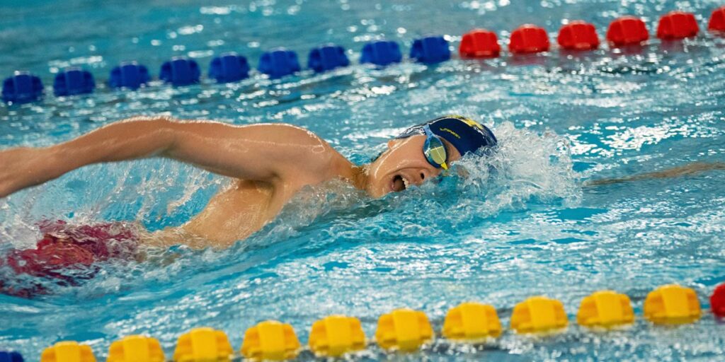 a man doing lap swimming in a swimming pool
