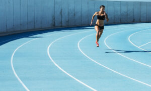 Runner holding a steady, controlled effort on a track during a tempo vs threshold training run