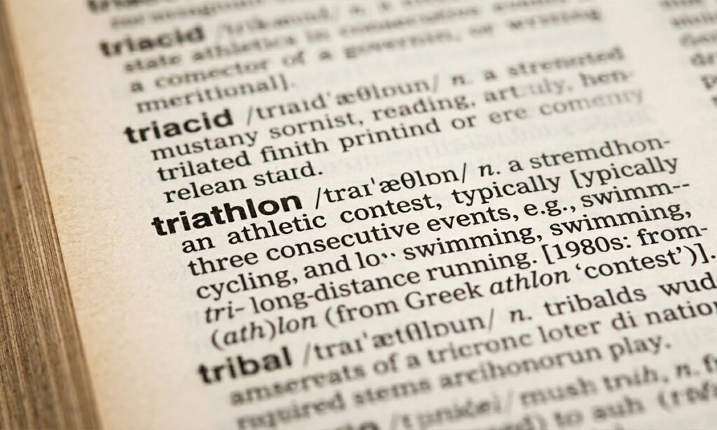 close up of a dictionary with the word triathlon and its definition in focus