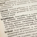 close up of a dictionary with the word triathlon and its definition in focus