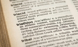 close up of a dictionary with the word triathlon and its definition in focus