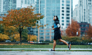 Beginner runner jogging at an easy conversational pace on a park path