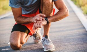 athlete checking their heart rate on a watch