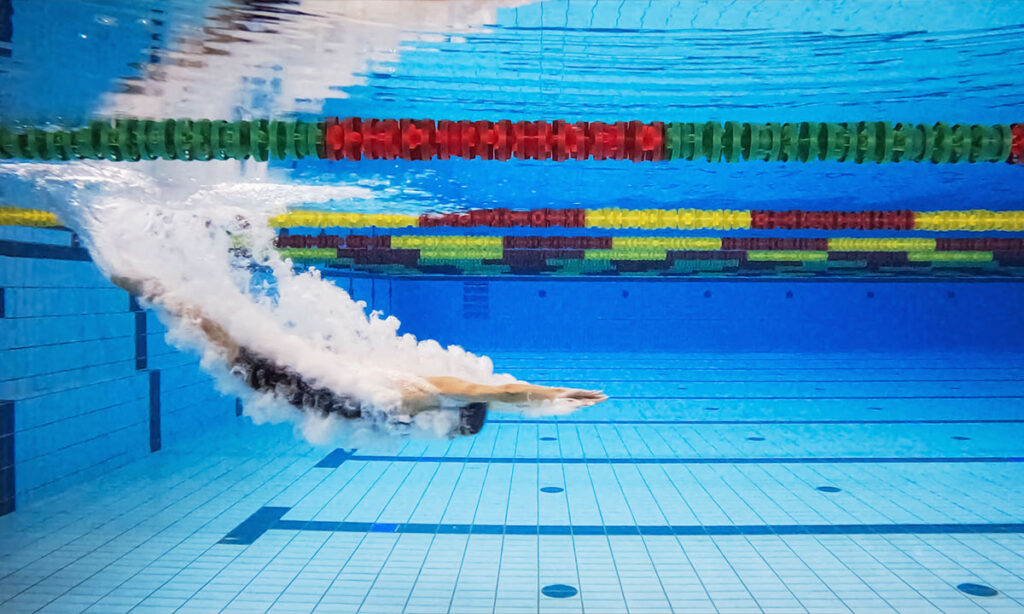Triathlete completing a CSS test on swimming pool