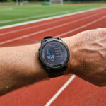 runner checking heart rate watch during an easy zone 2 run