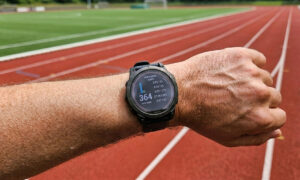 runner checking heart rate watch during an easy zone 2 run