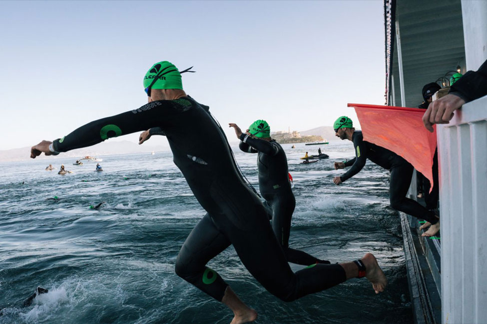 Swimmer entering water in the Escape from Alcatraz Triathlon