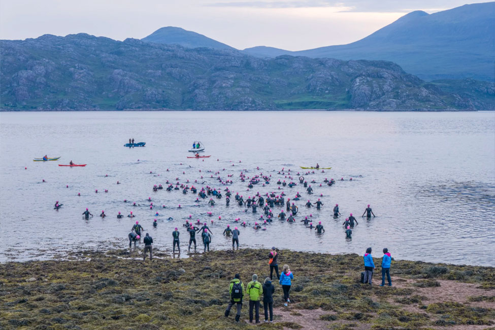 Swimmers entering the water during the 2025 Celtman Triathlon