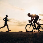 runner and a cyclist passing each other during zone 2 training