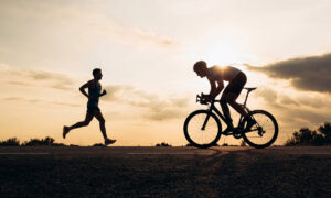 runner and a cyclist passing each other during zone 2 training