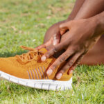 runner feeling pain in her shin dues to shin splints